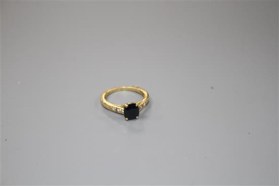 A modern 18ct gold and oval cut sapphire ring, with diamond set shoulders, size M, gross weight 3.4 grams.